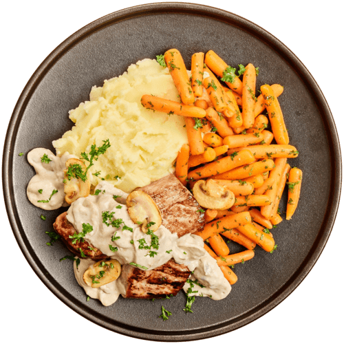 Varkenshaas in champignonsaus, wortels en aardappelpuree