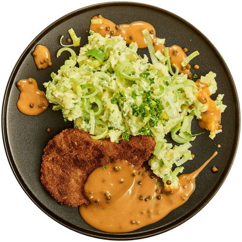 Stamppot van prei met kipschnitzel en pepersaus